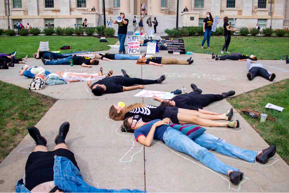 A "die-in" protest of the university's lax COVID-19  protections -- graduate workers lie on the ground in front of the Pentacrest.